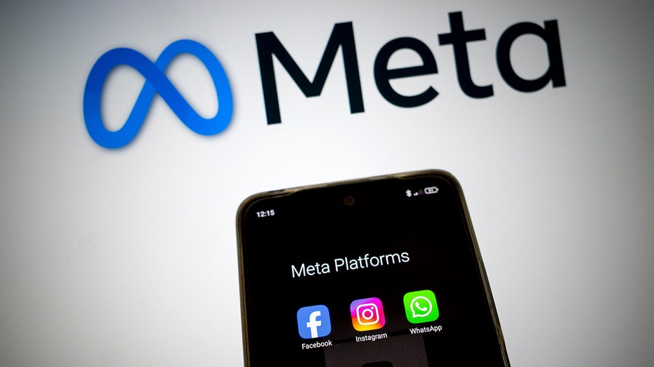 Meta various platforms on smartphone screen with Meta logo in background 