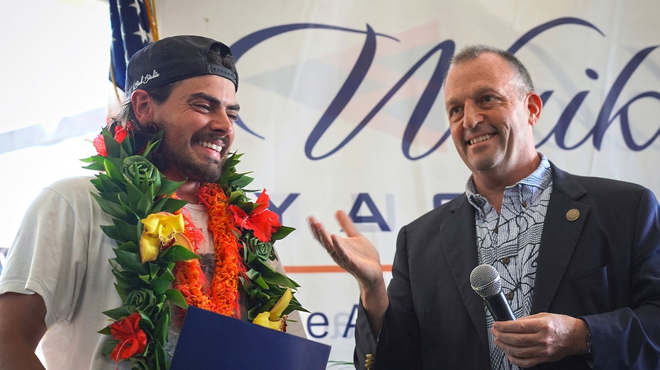 Governor Josh Green presents a proclamation to Oliver Widger