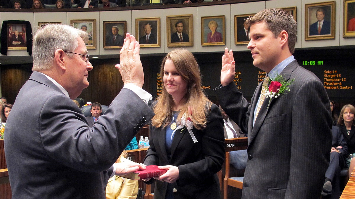 FILE - In this Nov. 20, 2012, file photo State Sen. Don Gaetz, R-Niceville, left, is sworn in as Senate president by his son, state Rep. Matt Gaetz, R-Fort Walton Beach, as his daughter, Erin, holds the family bible on Tuesday, Nov. 20, in Tallahassee, Fla. (AP Photo/Bill Cotterell, File)
