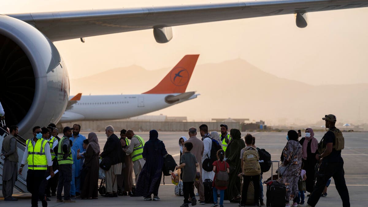 People board a Qatar Airways aircraft at the airport in Kabul, Afghanistan, on Sept. 9, 2021.