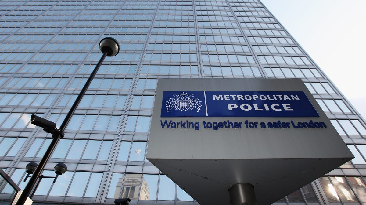 London metropolitan police sign with building in background