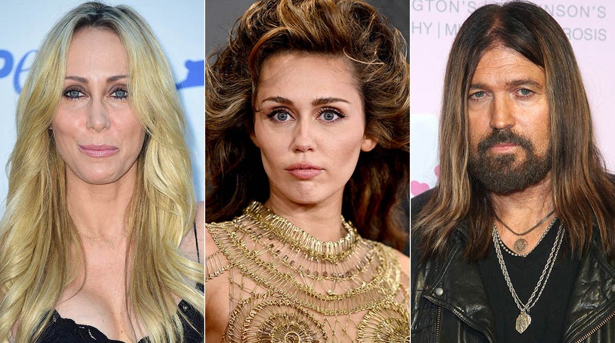 Miley Cyrus walks the red carpet at the Grammys in gold