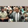 O.J. Simpson shows the jury a new pair of Aris extra-large gloves, similar to the gloves found at the Bundy and Rockingham crime scene