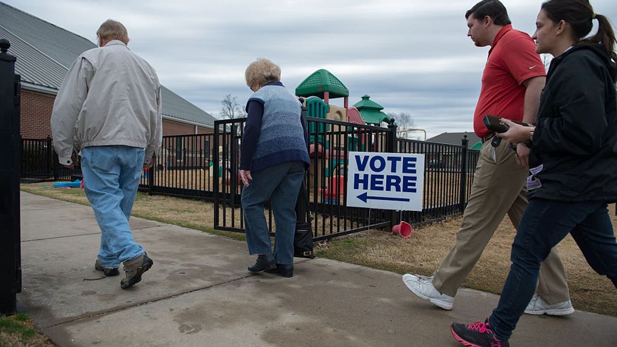Voters arrive to cast their ballots at Grace United Methodist Church on March 1, 2016, in Conway, Arkansas.