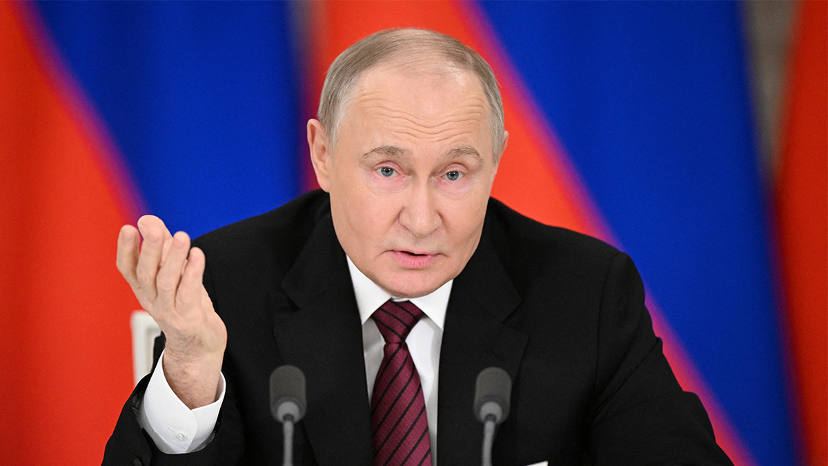 Putin speaking into a microphone